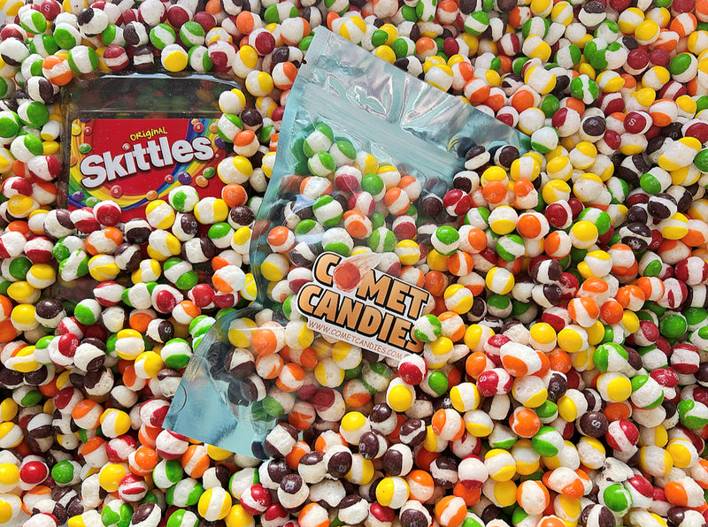 Resealable bag of colorful Rainbow Skrillerz freeze-dried Skittles surrounded by puffed candy pieces